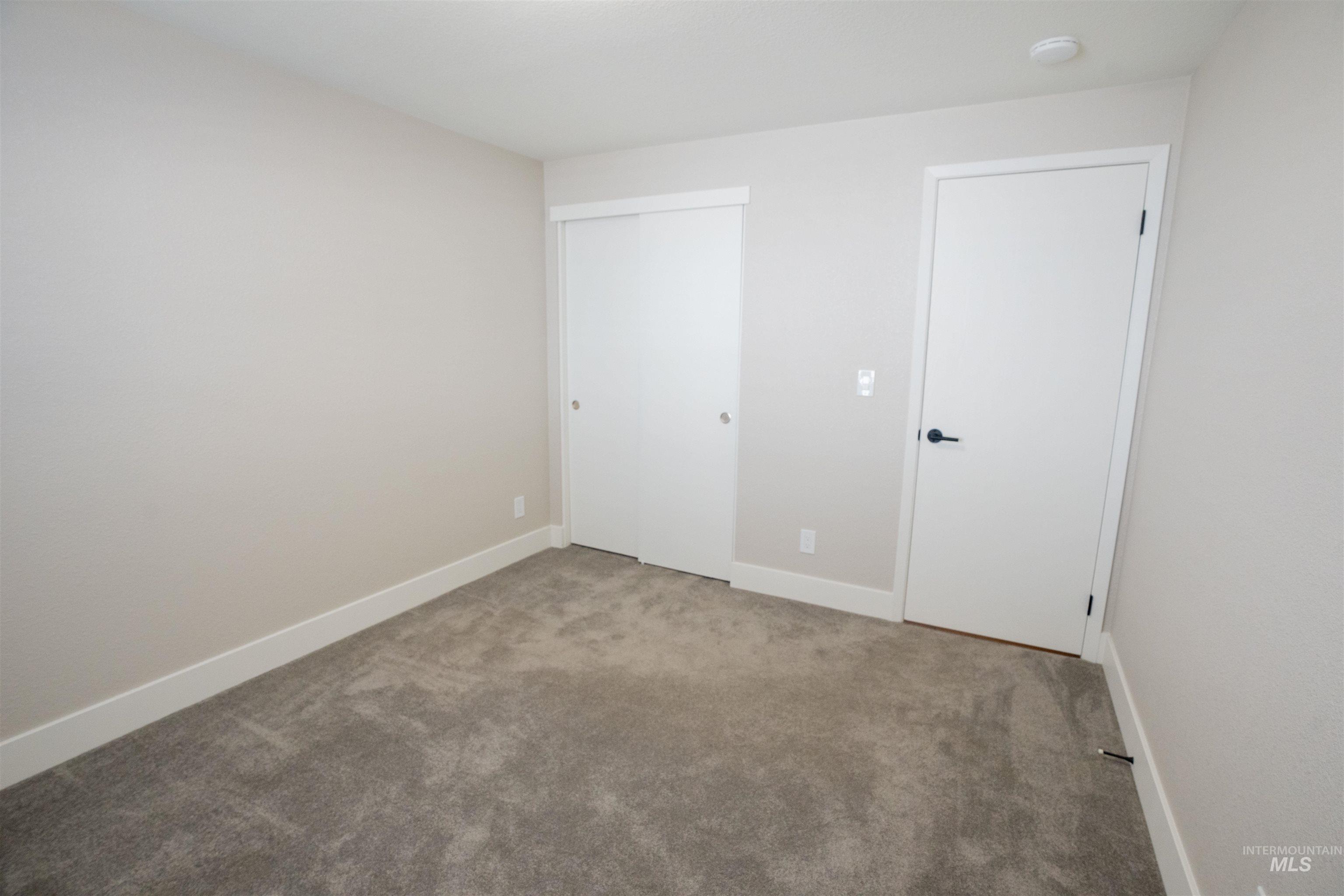 Unfurnished bedroom with carpet and a closet