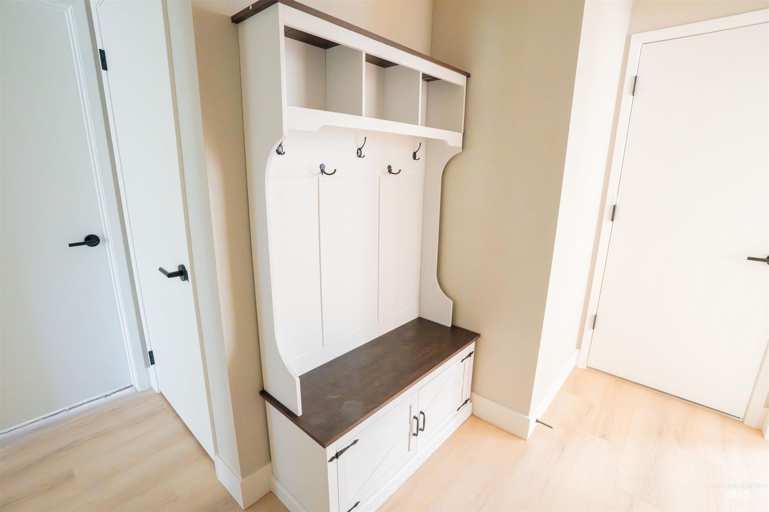 Mudroom with light wood-style floors and baseboards