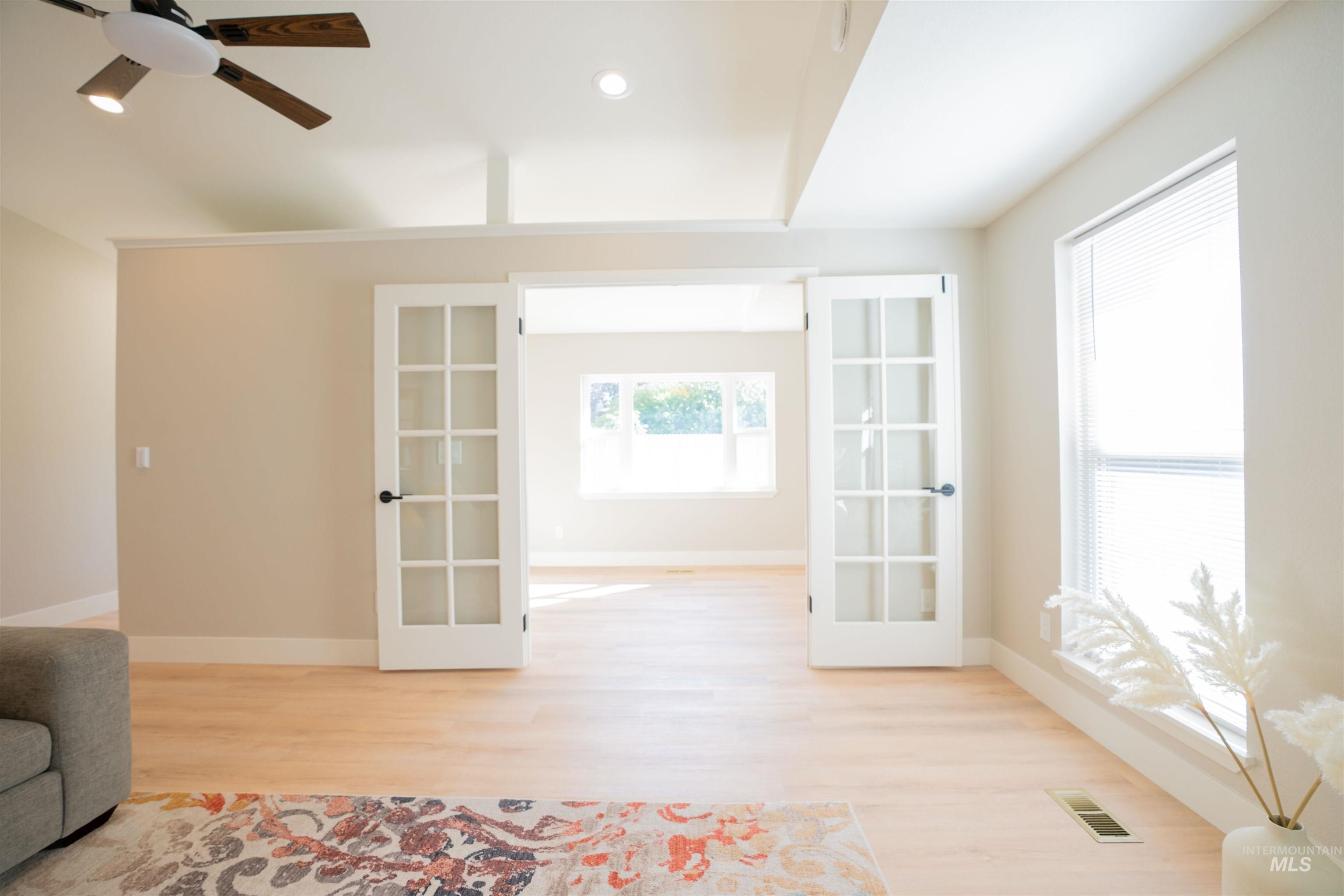 Unfurnished room featuring french doors, recessed lighting, light wood-style flooring, and a ceiling fan