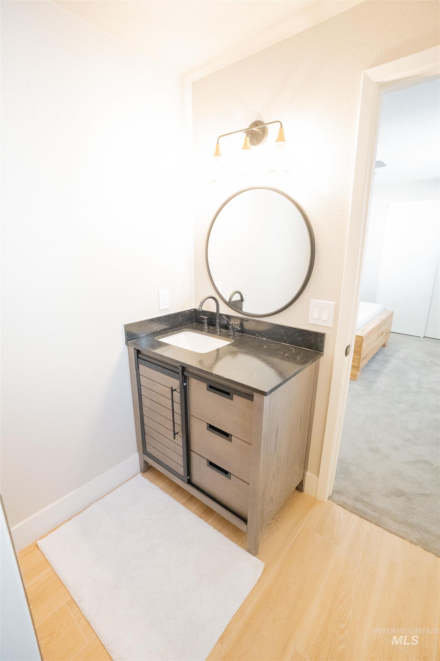 Bathroom featuring vanity and light wood-type flooring