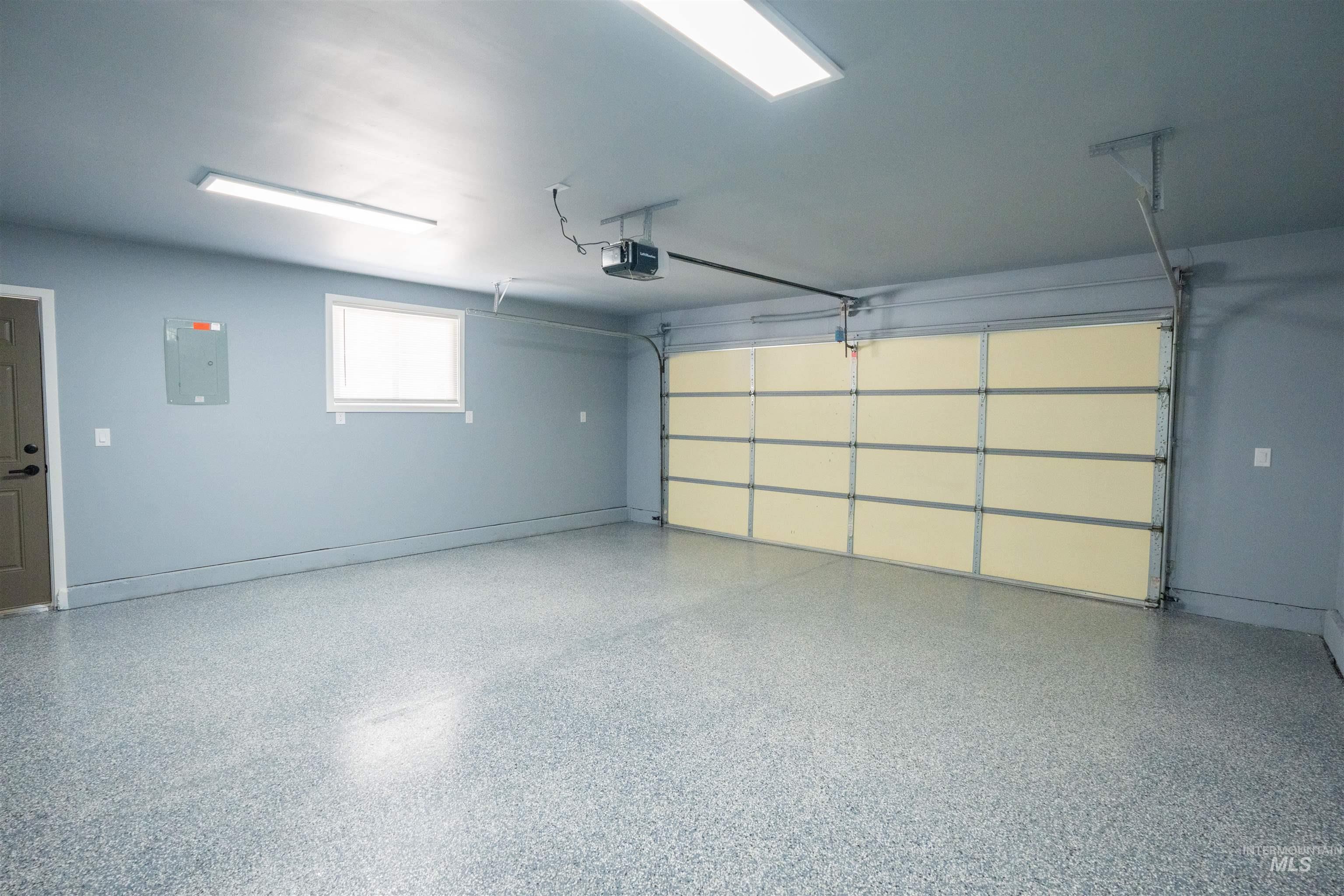 Garage with electric panel and a garage door opener