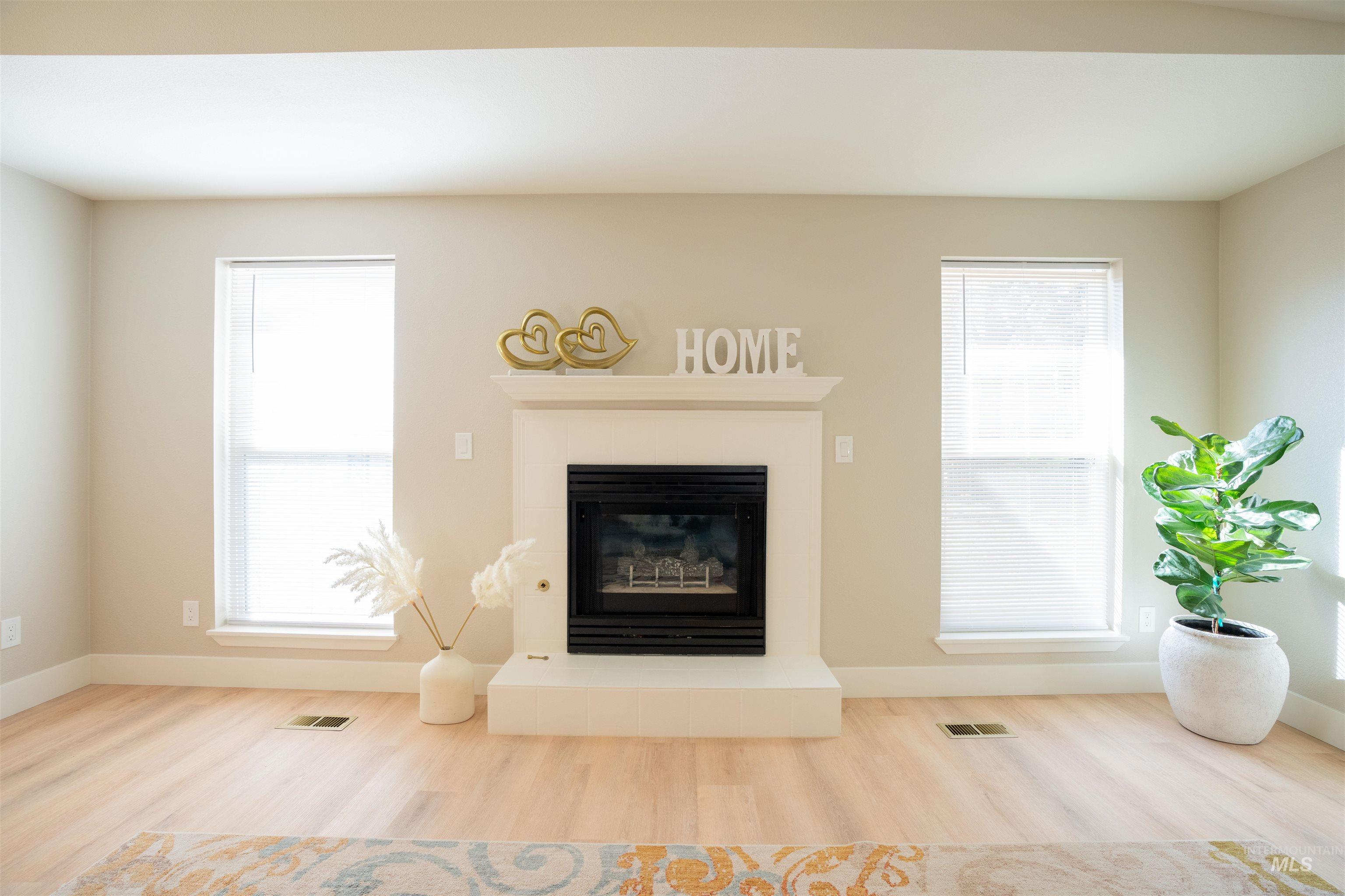 Living area featuring a tile fireplace and wood finished floors