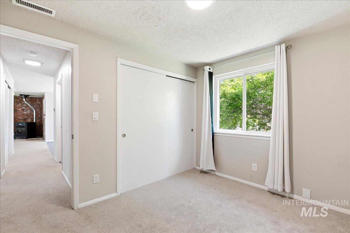 Carpeted room with a white sliding closet door