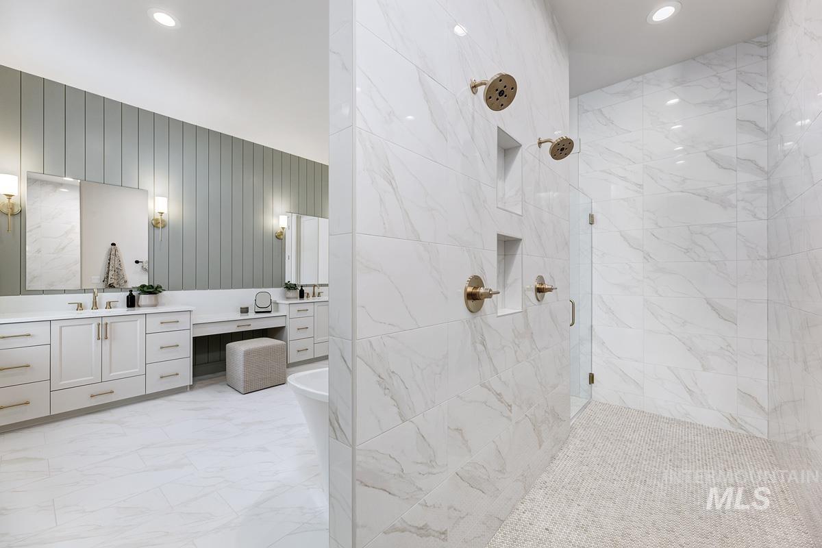 Full bath with a marble finish shower, light marble finish floors, vanity, a freestanding tub, and recessed lighting