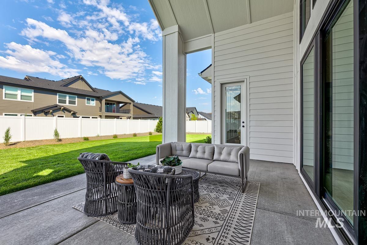 Fenced backyard featuring a patio, outdoor lounge area, and a residential view