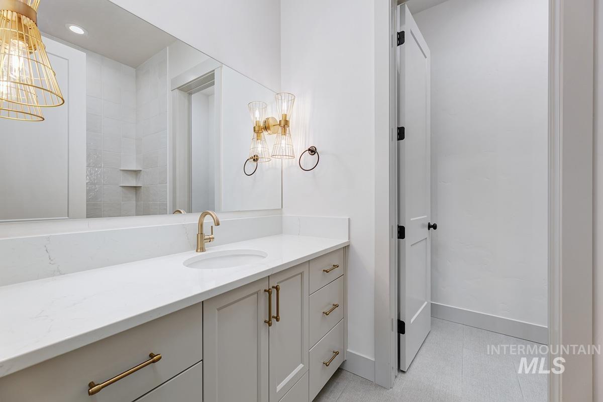 Bathroom featuring vanity and a chandelier