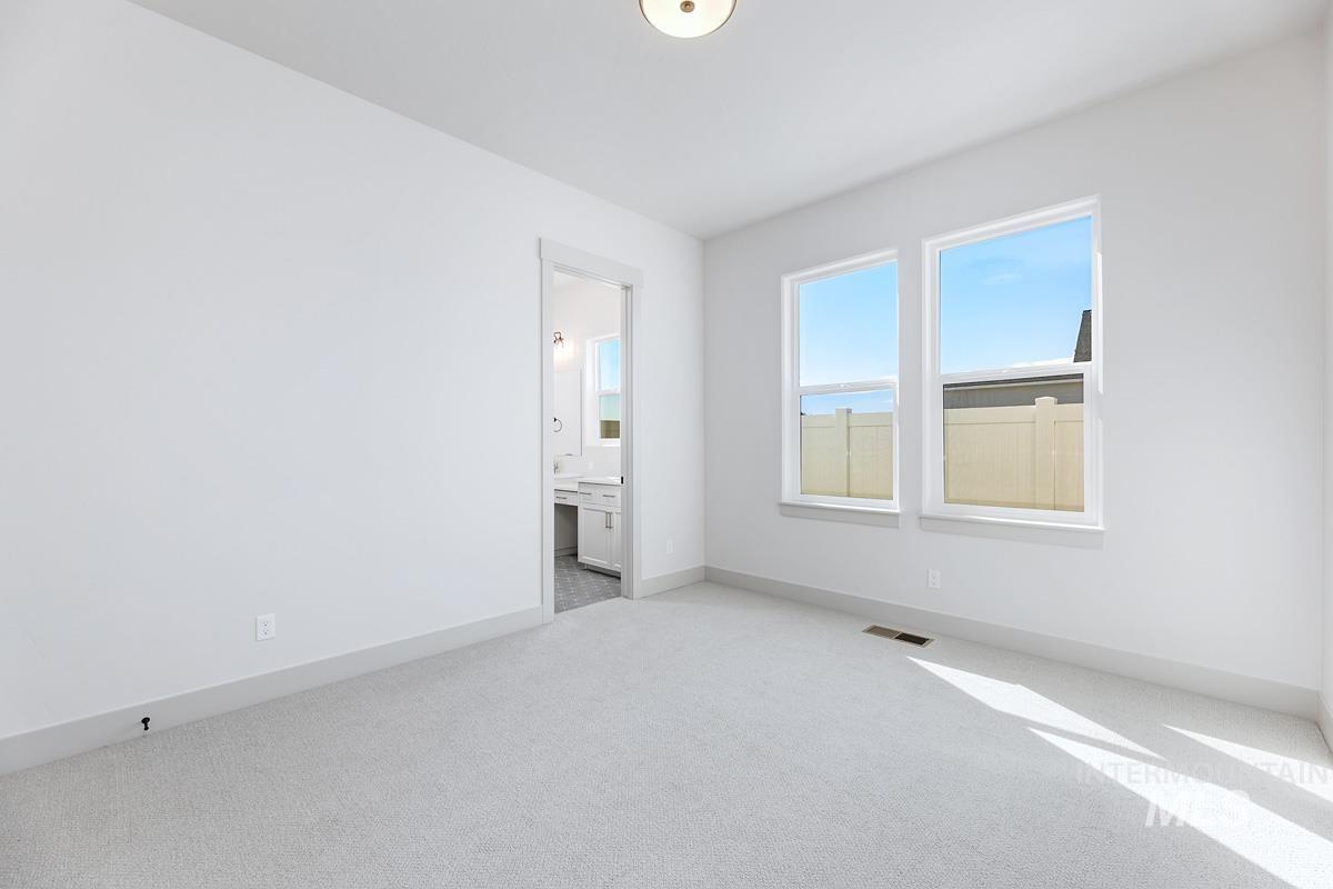 Empty room with light carpet and baseboards