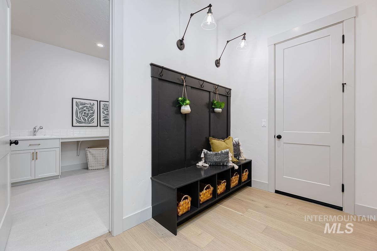 Mudroom with recessed lighting and light wood finished floors