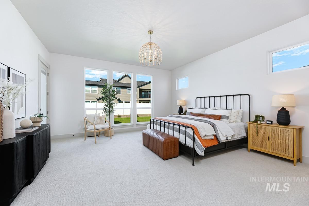 Bedroom featuring carpet flooring and a chandelier