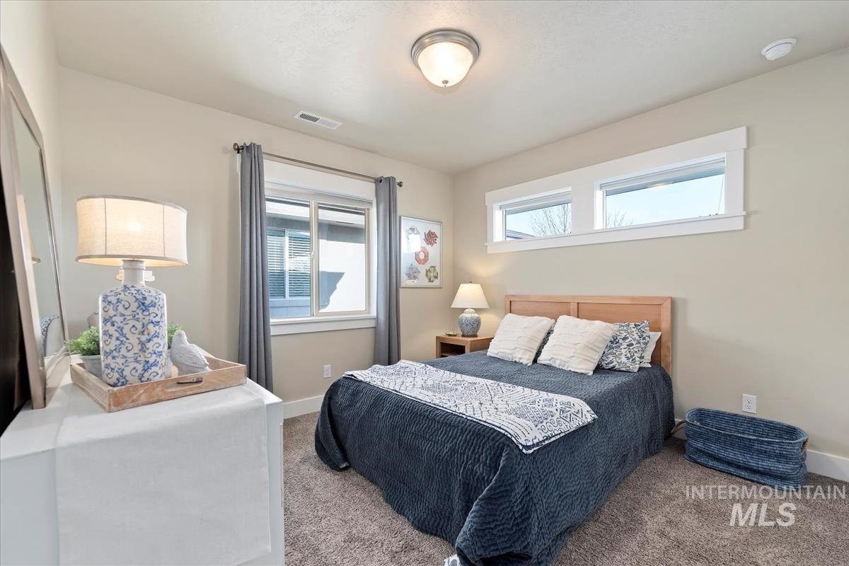 Carpeted bedroom with baseboards