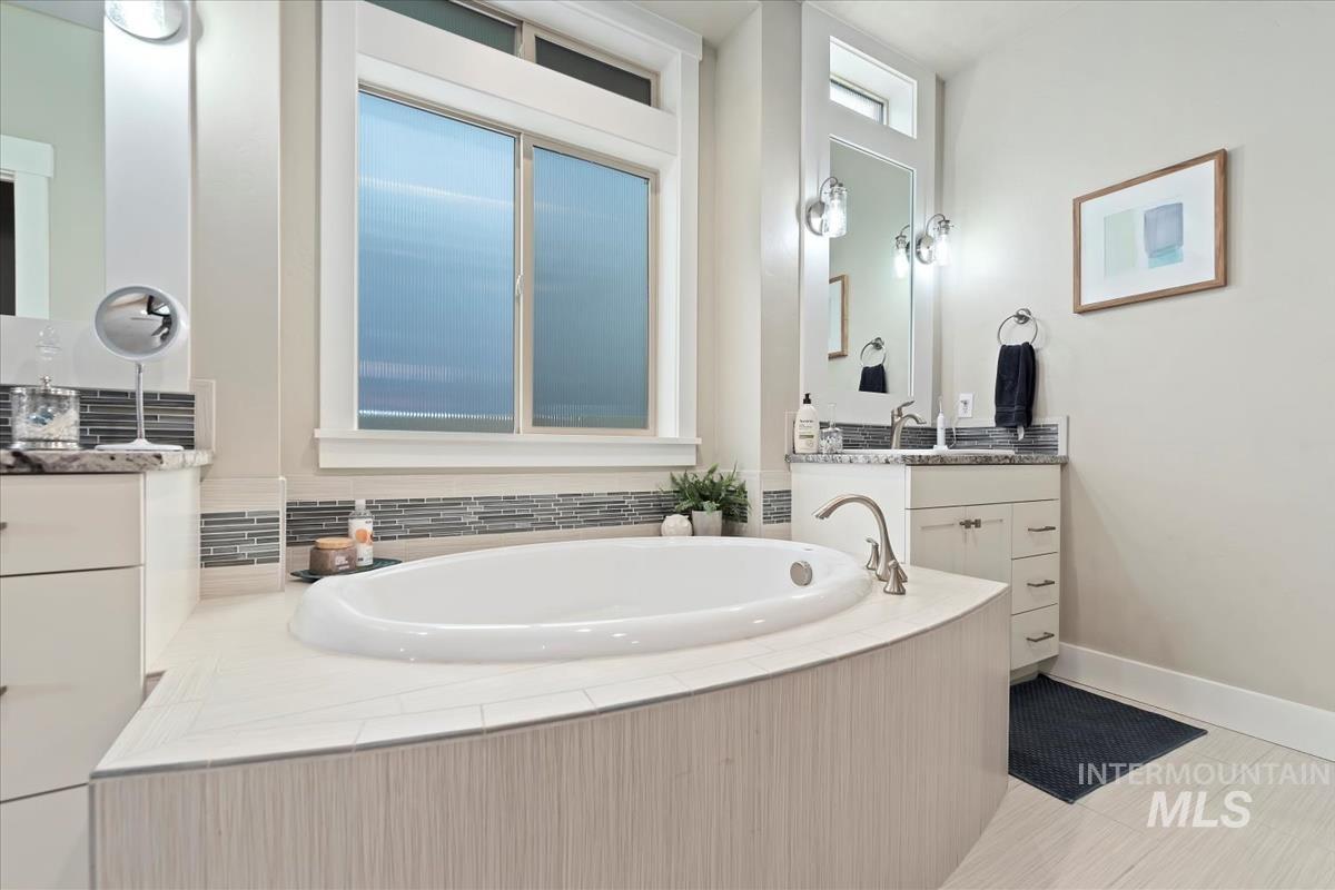 Full bathroom with vanity and a bath