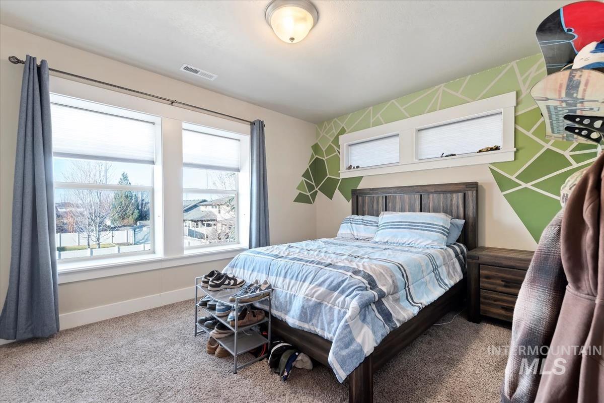 Carpeted bedroom with baseboards
