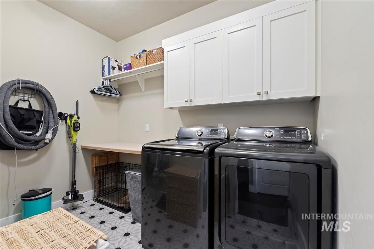 Laundry room featuring cabinet space and washer and clothes dryer