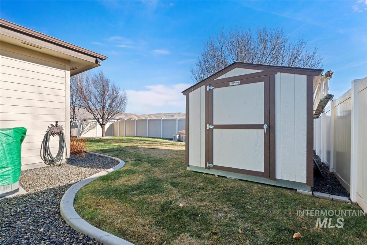 View of shed featuring a fenced backyard