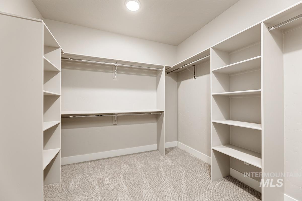 Spacious closet with light colored carpet