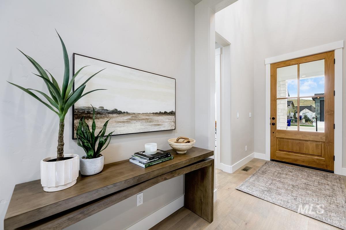 Entryway with light wood-style flooring and baseboards