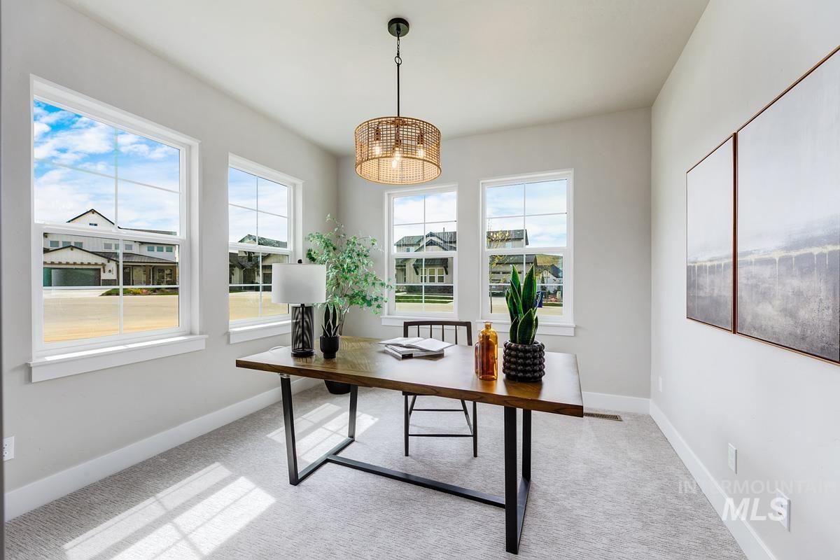 Office space with light carpet and baseboards