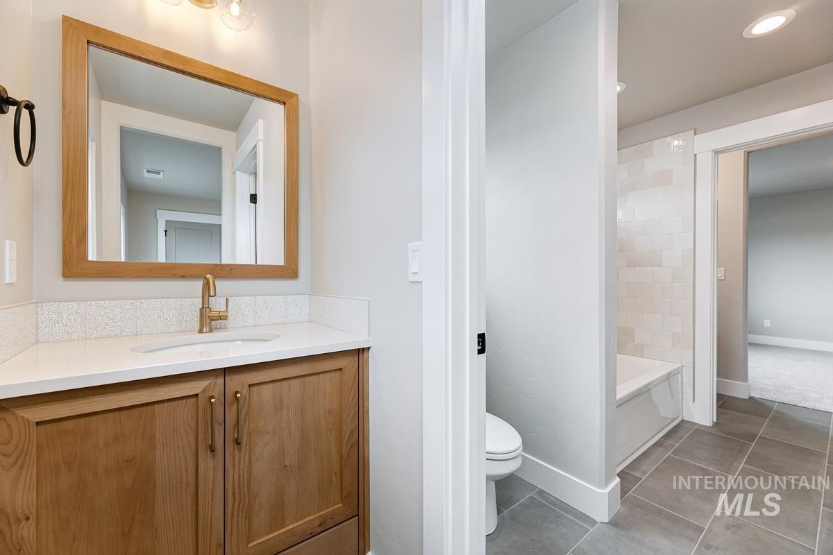 Full bathroom featuring vanity, tile patterned flooring, and bathtub / shower combination