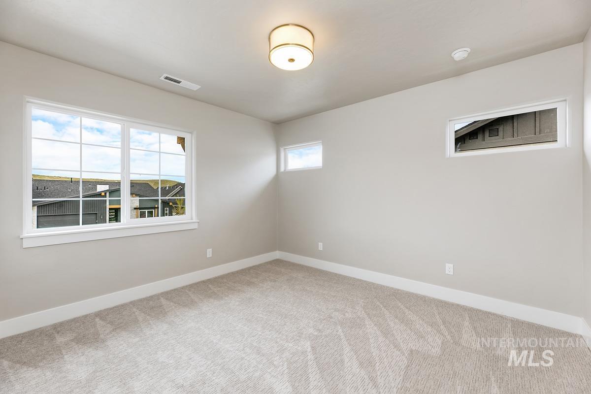 Unfurnished room featuring baseboards and light colored carpet