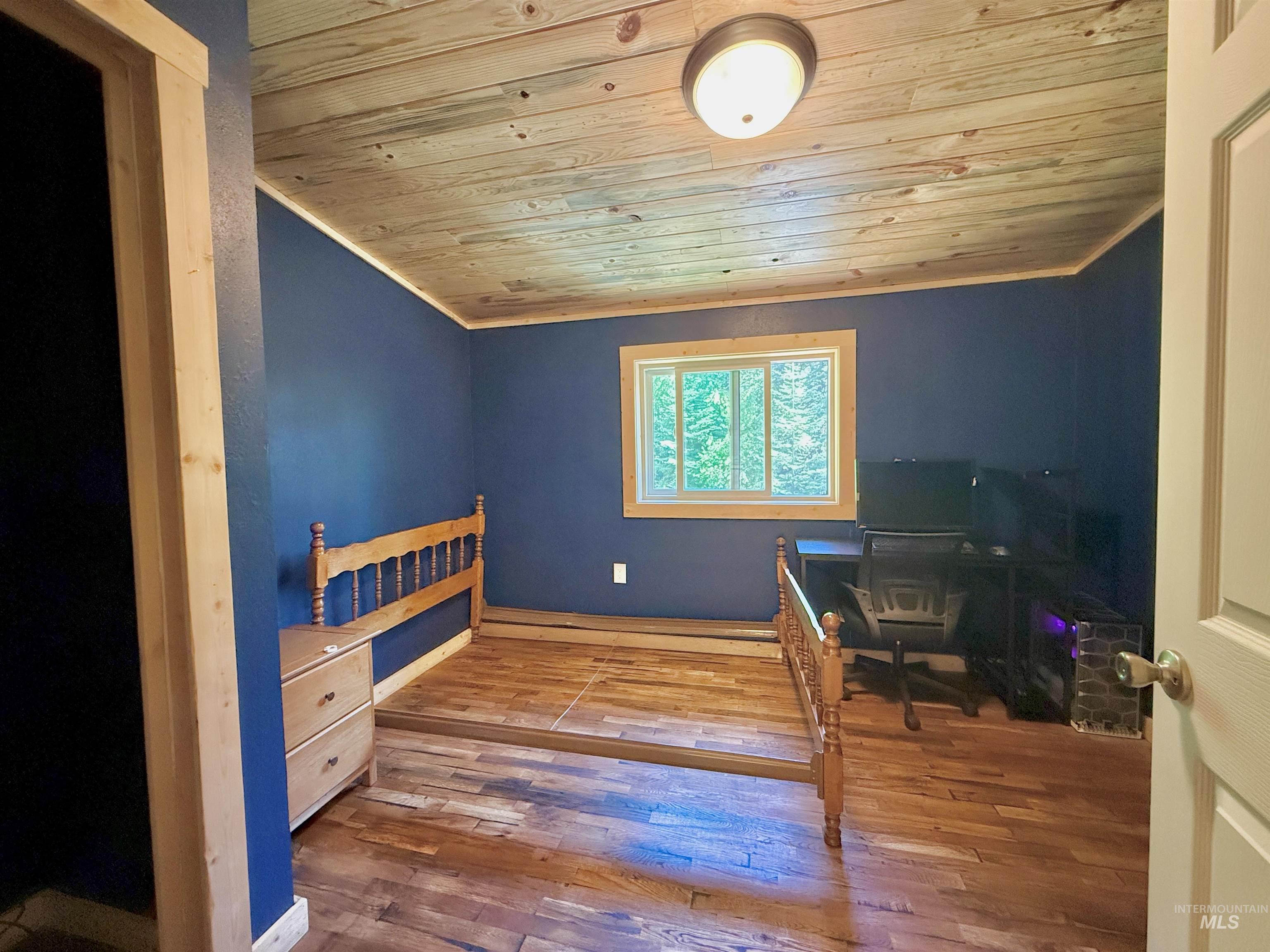 Home office featuring wooden ceiling and hardwood / wood-style floors