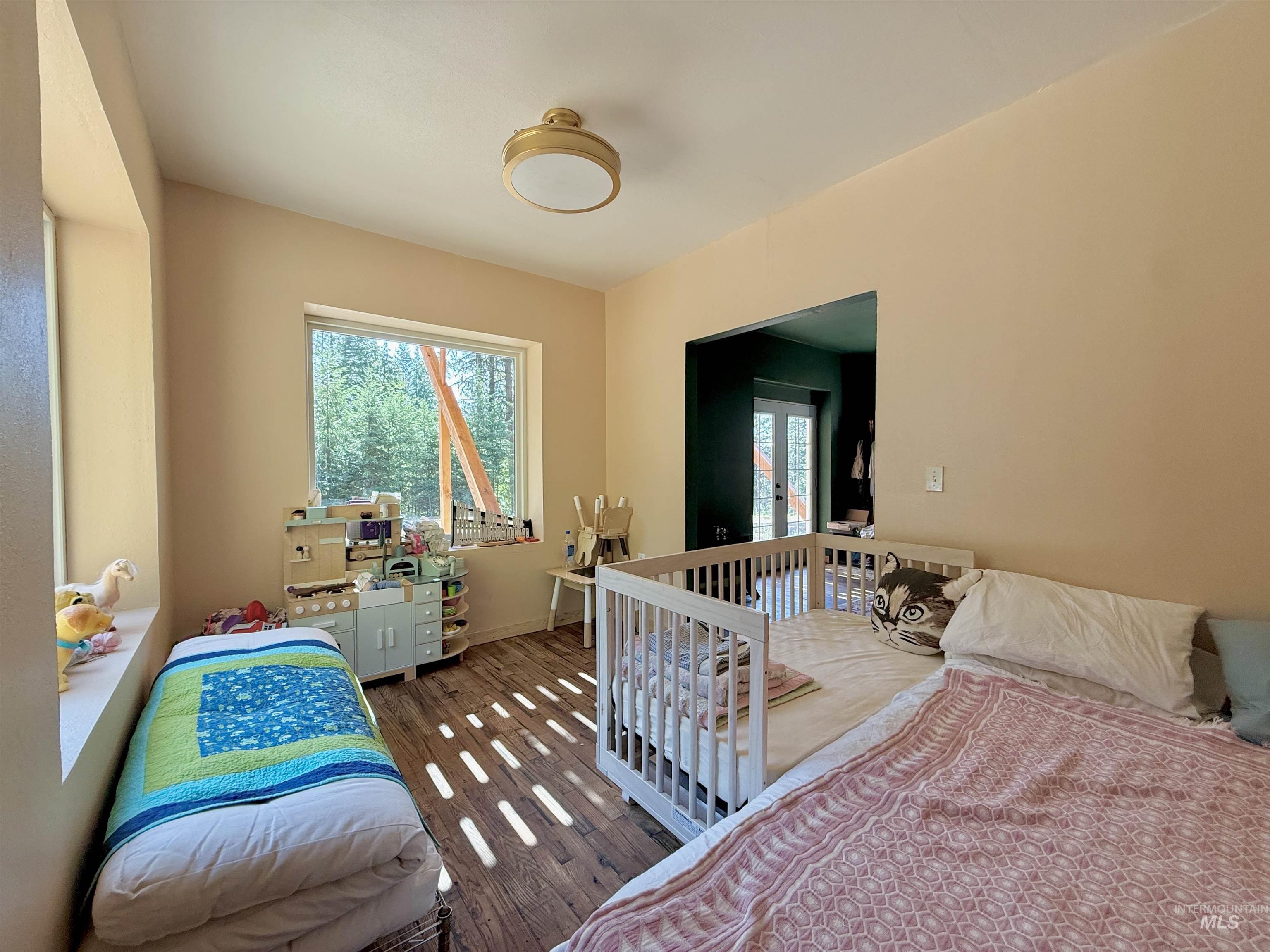Bedroom with wood finished floors and baseboards