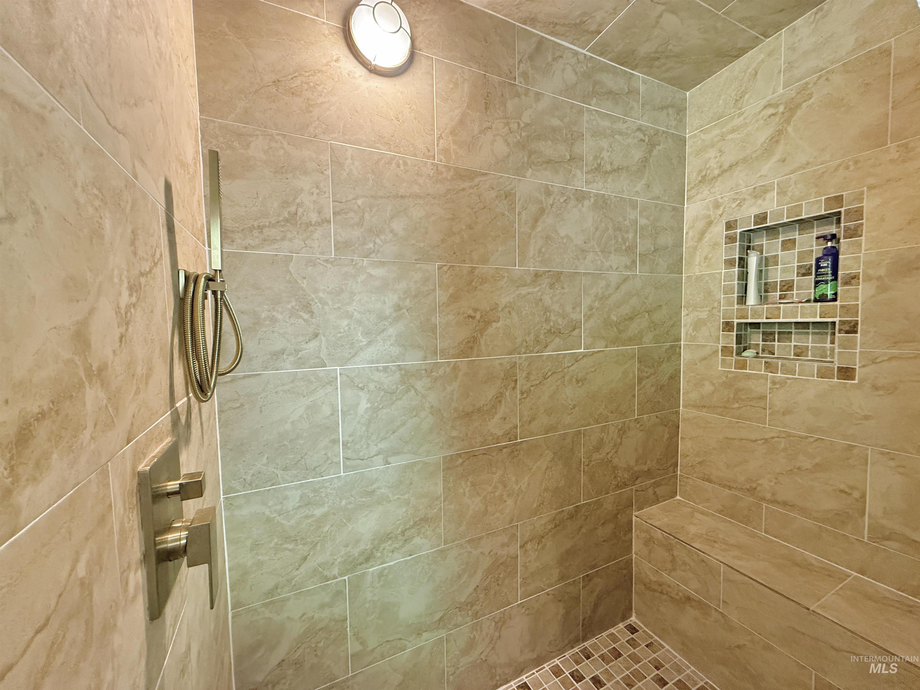 Full bathroom with tiled shower