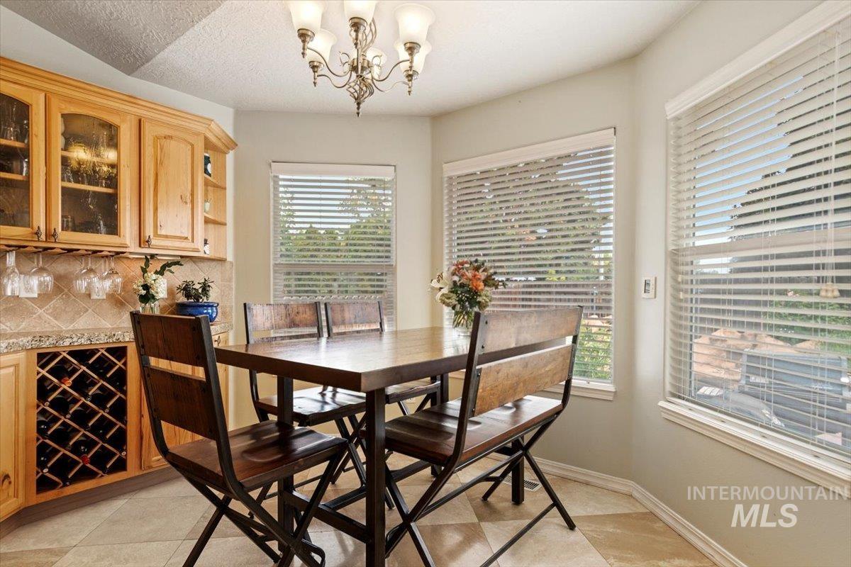 Dining area with hanging lights and light tile patterned floors
