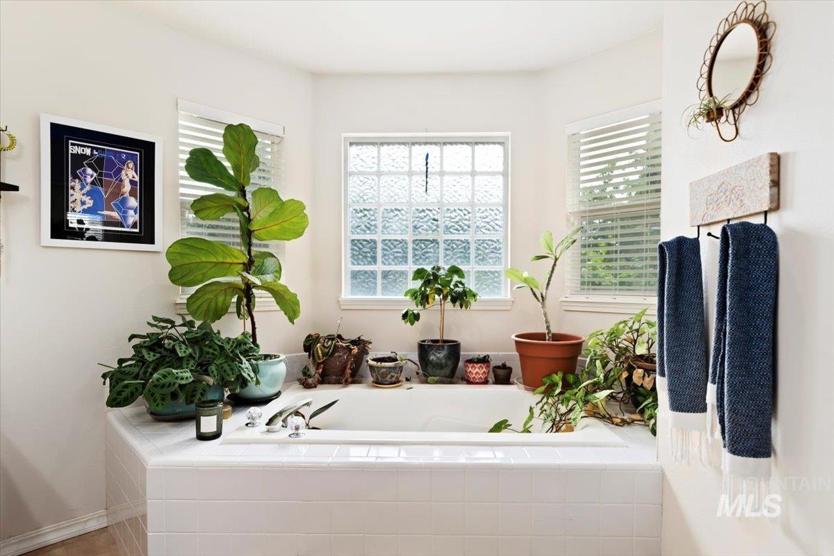 Full bathroom featuring a bath and healthy amount of natural light