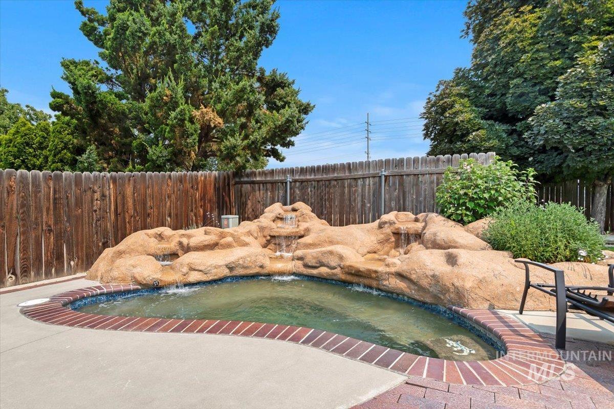 View of pool with a fenced backyard and patio surround