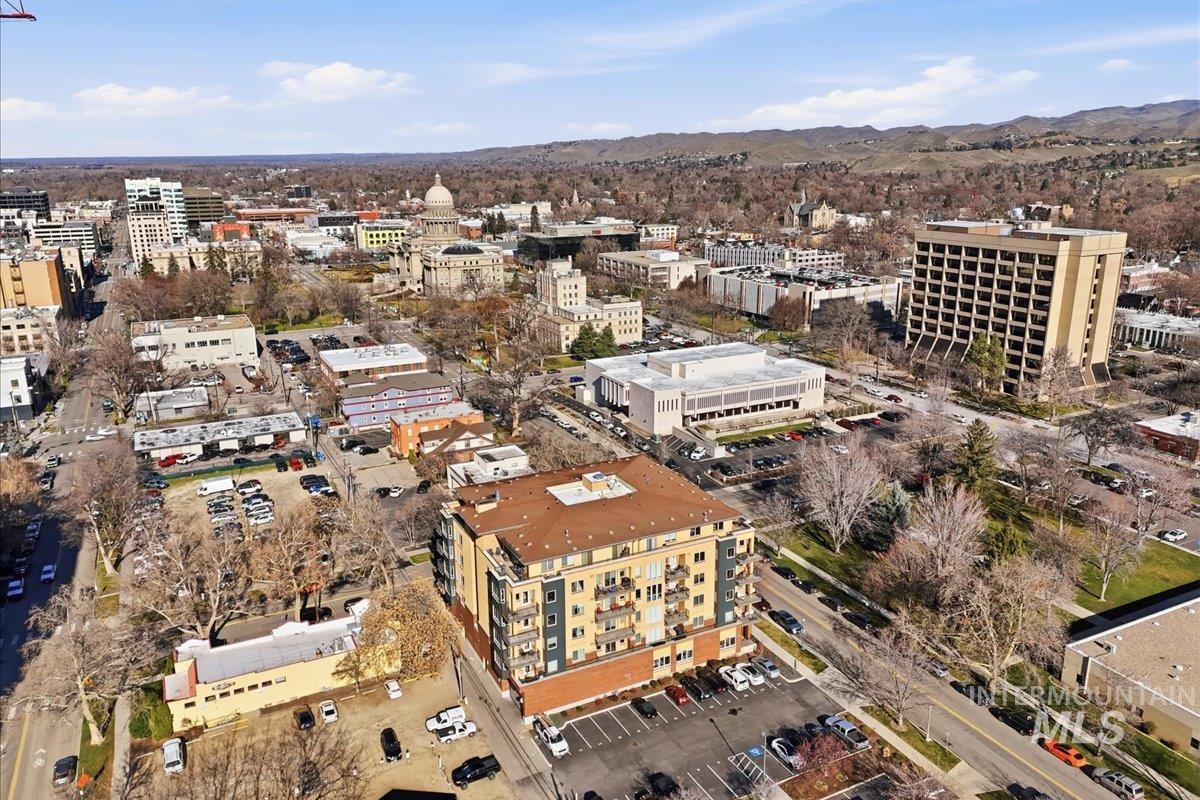 Aerial view of property and surrounding area with nearby urban area