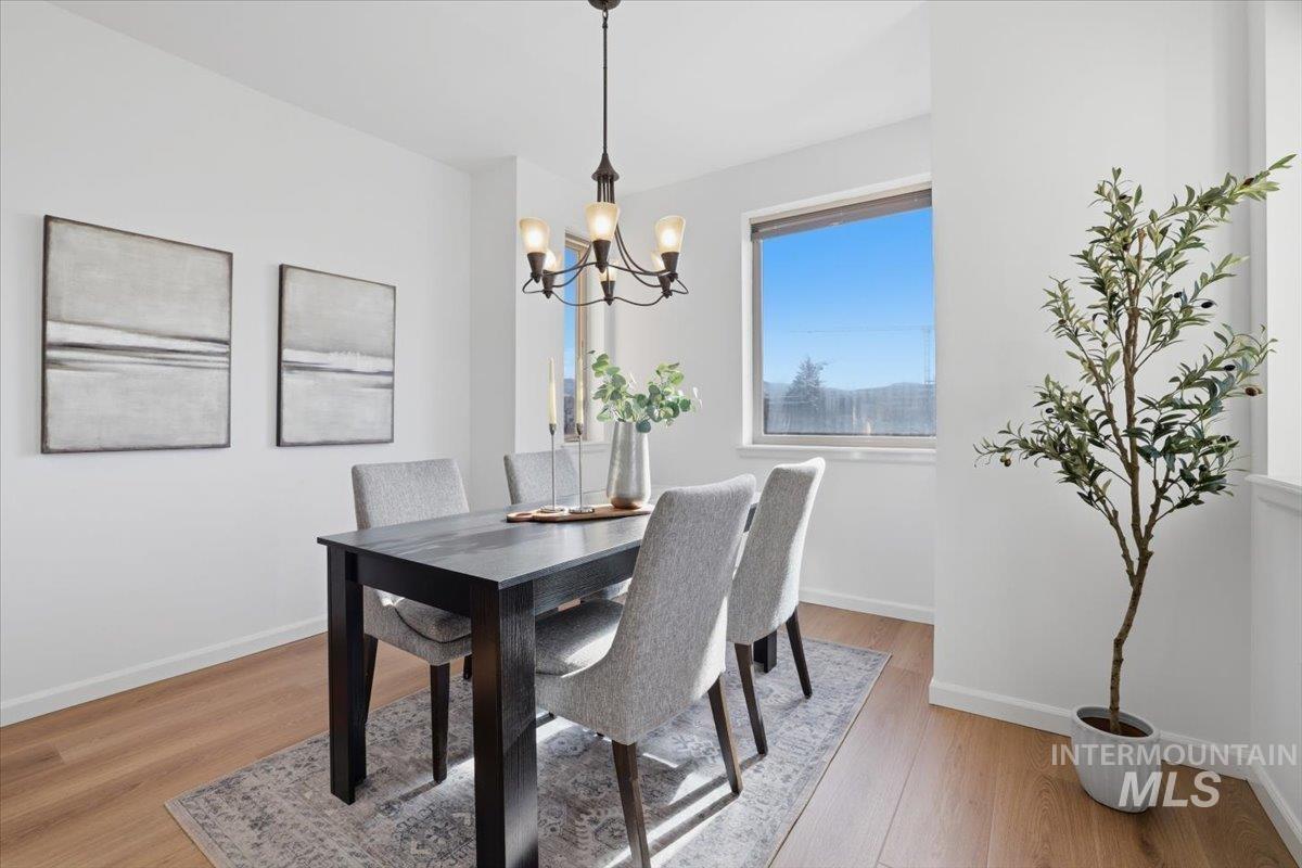 Dining area featuring light wood-style floors and a chandelier