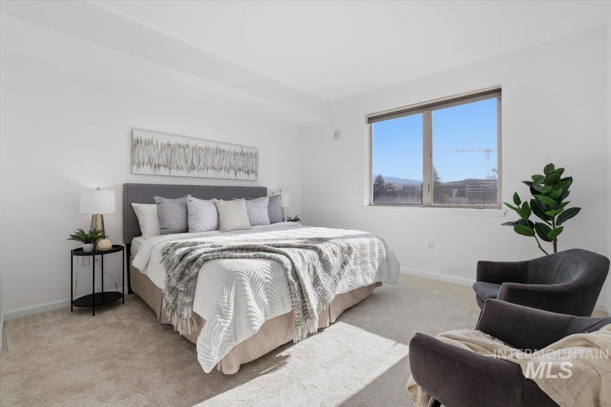 Bedroom with carpet floors and baseboards