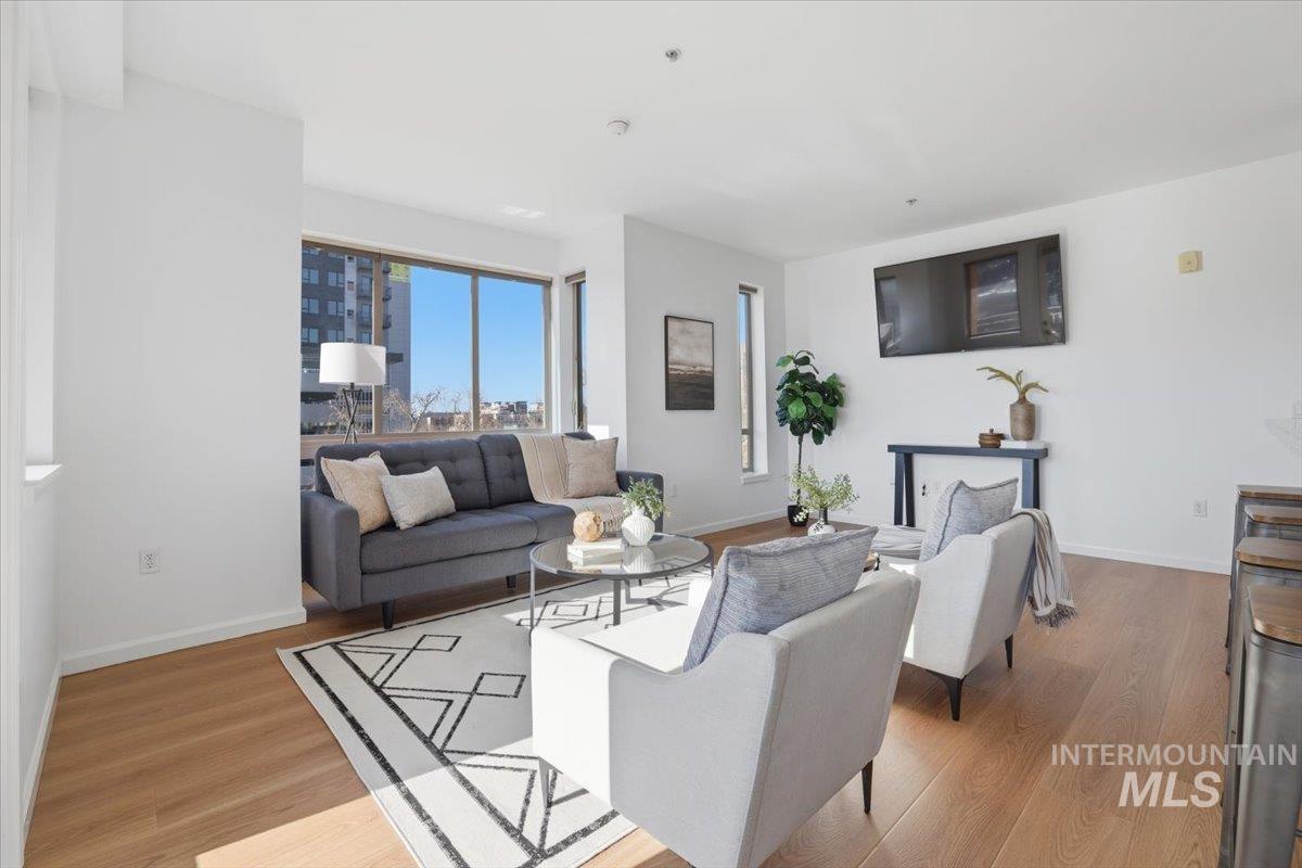 Living area featuring baseboards and light wood-style floors
