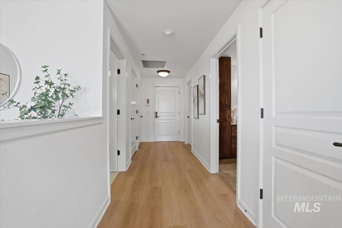 Hallway featuring baseboards and light wood-style flooring