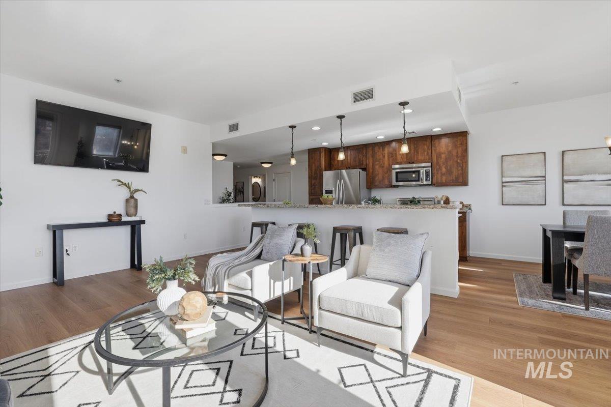 Living area featuring light wood-style floors and recessed lighting
