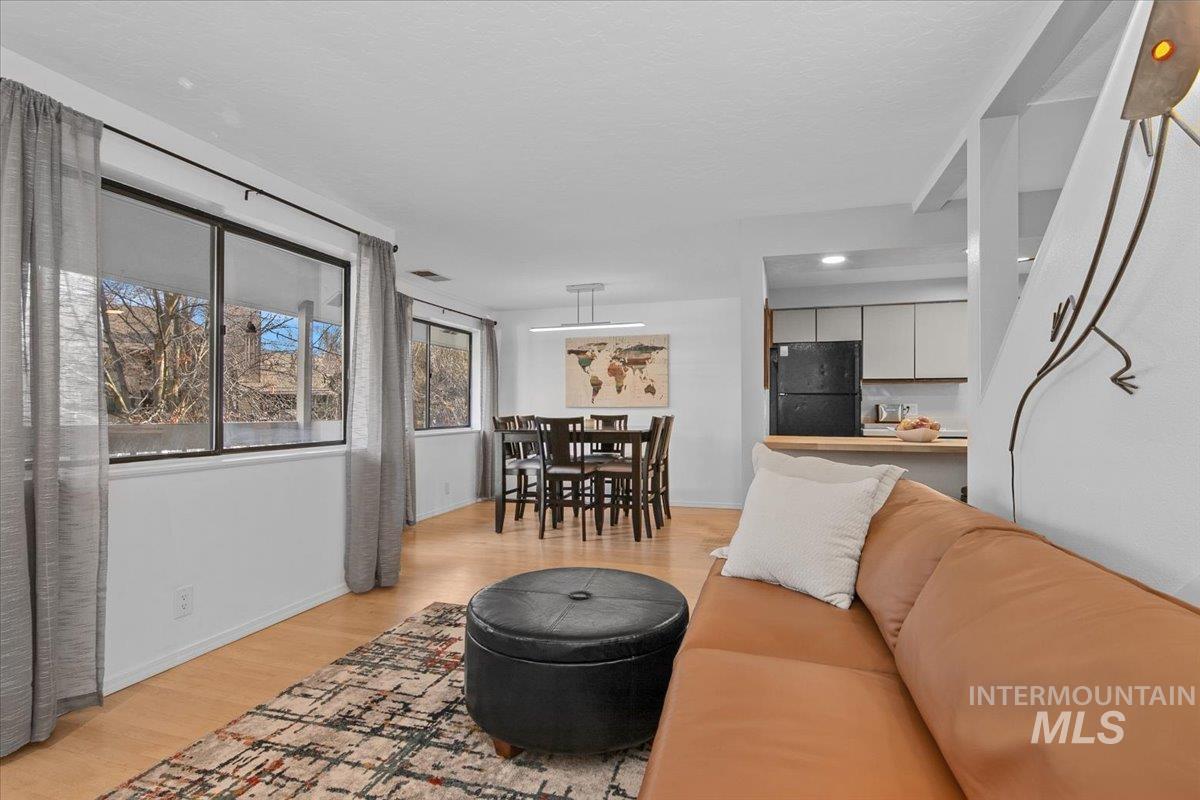 Living area featuring light wood-type flooring and baseboards