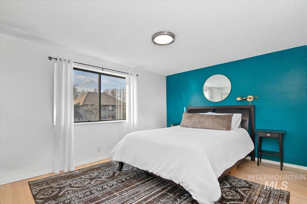 Bedroom featuring light wood finished floors and a textured ceiling