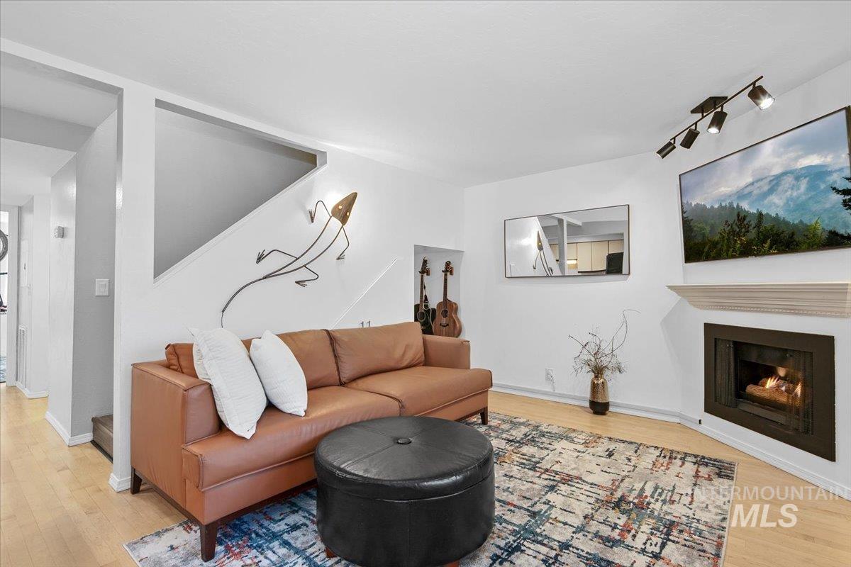 Living area featuring a lit fireplace and light wood finished floors