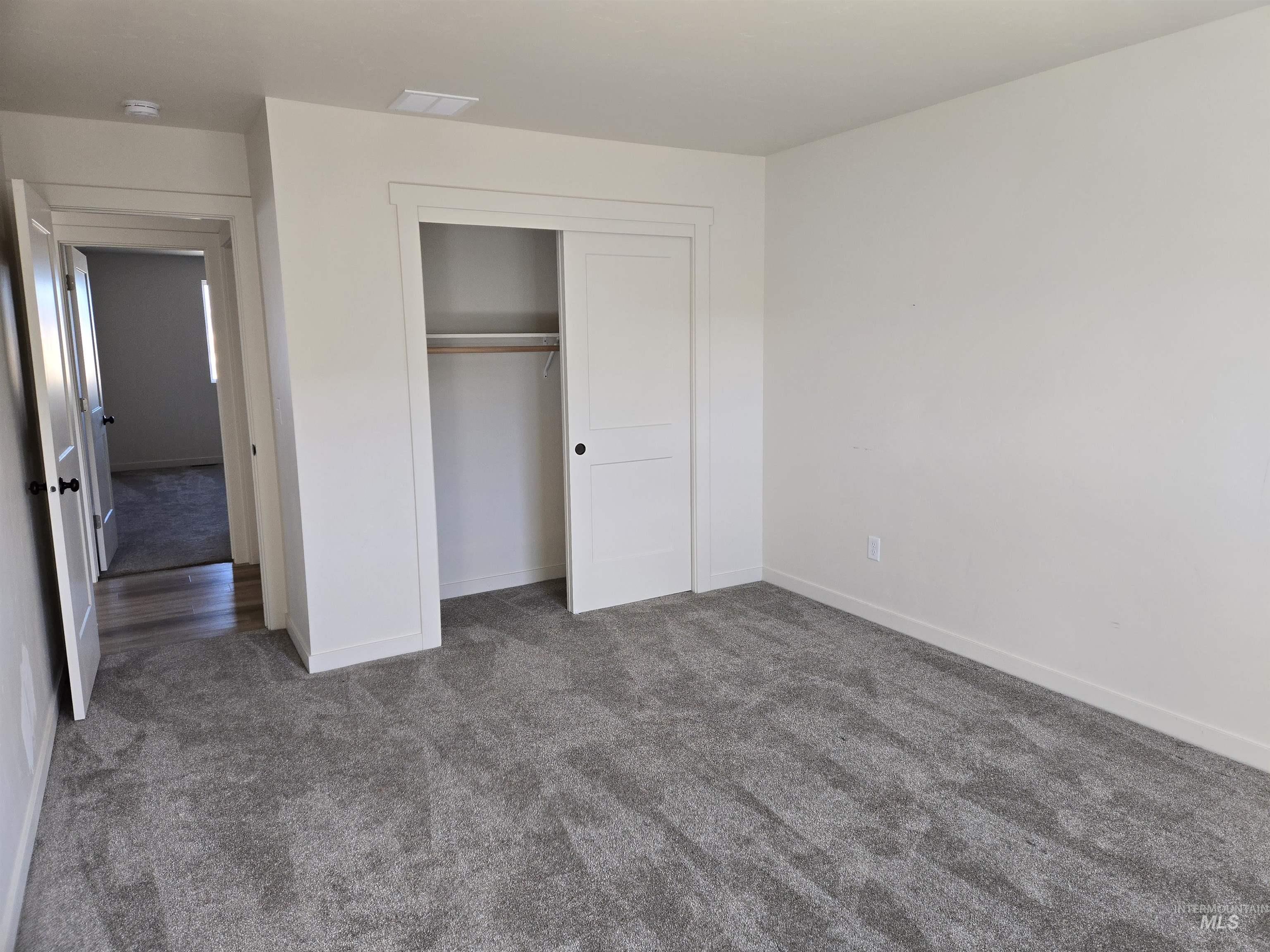 Unfurnished bedroom featuring carpet floors and a closet