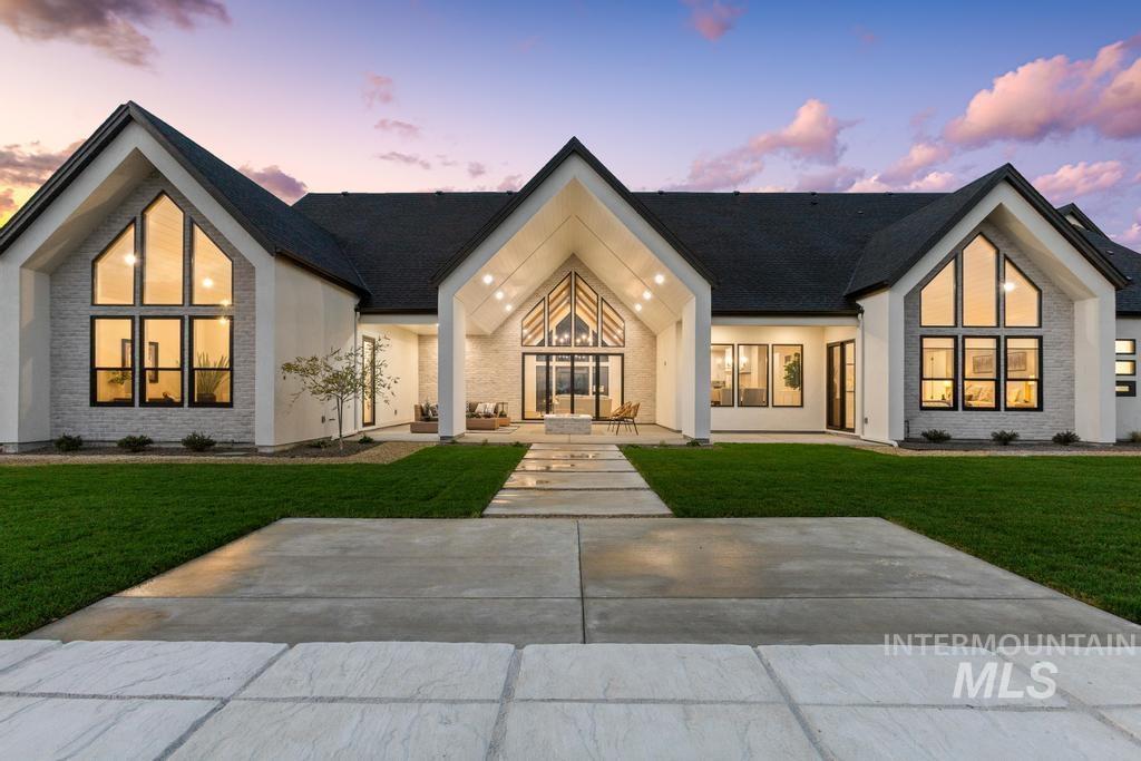 View of front of property featuring a front lawn and a patio