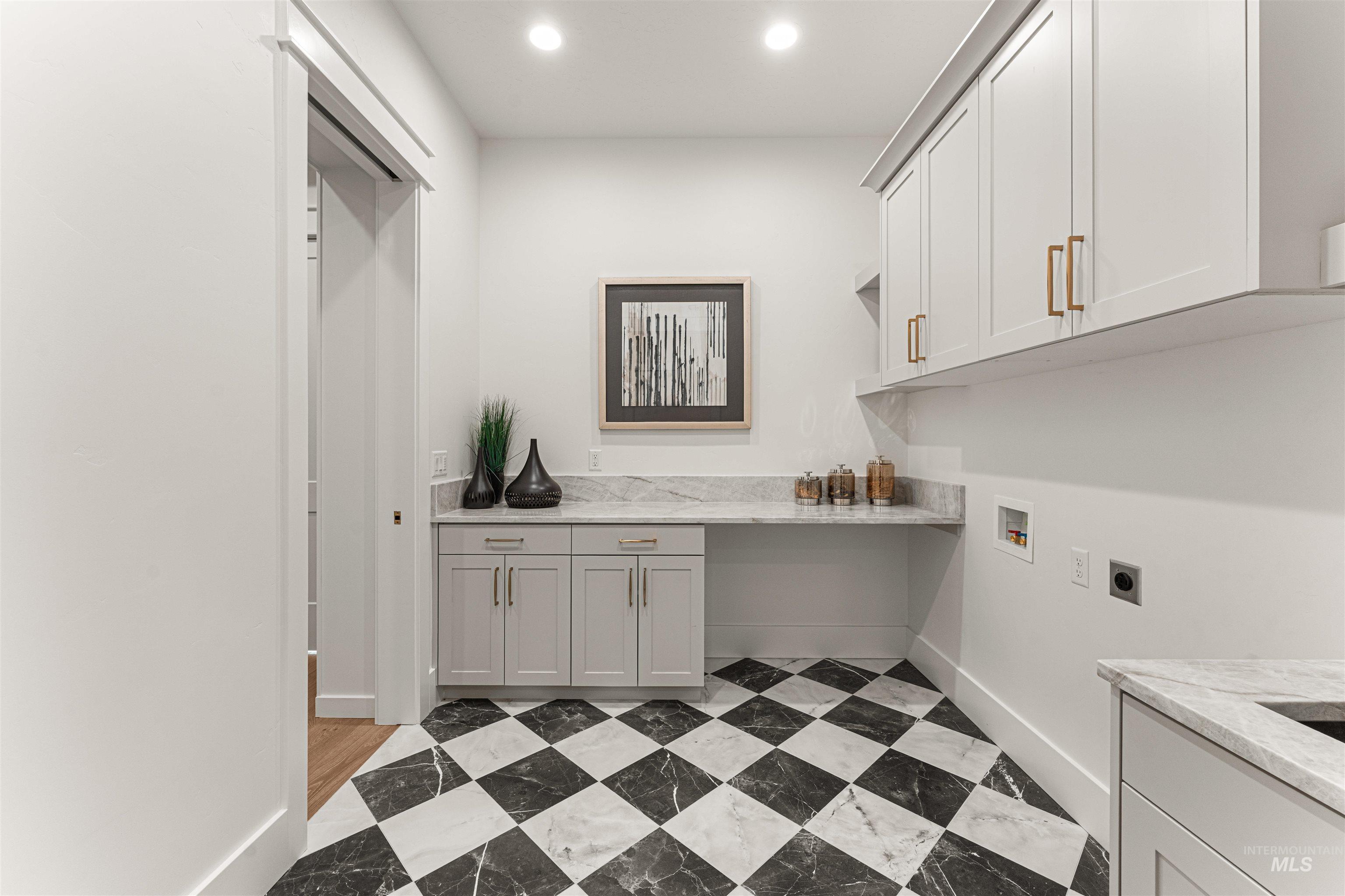 Laundry area featuring cabinet space, hookup for a washing machine, electric dryer hookup, and recessed lighting