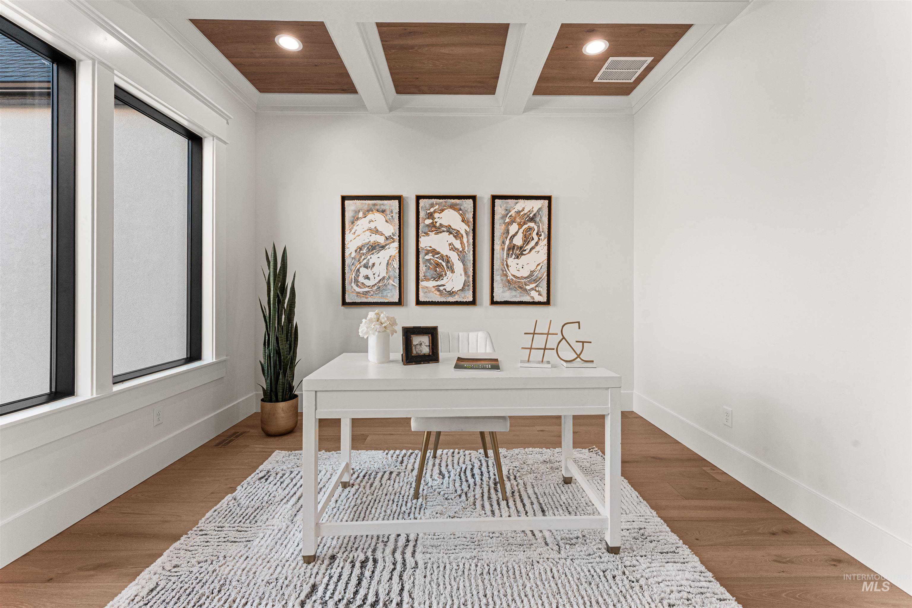 Office space with wood finished floors, recessed lighting, beamed ceiling, coffered ceiling, and crown molding