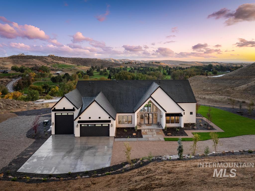 Modern inspired farmhouse with a garage and driveway