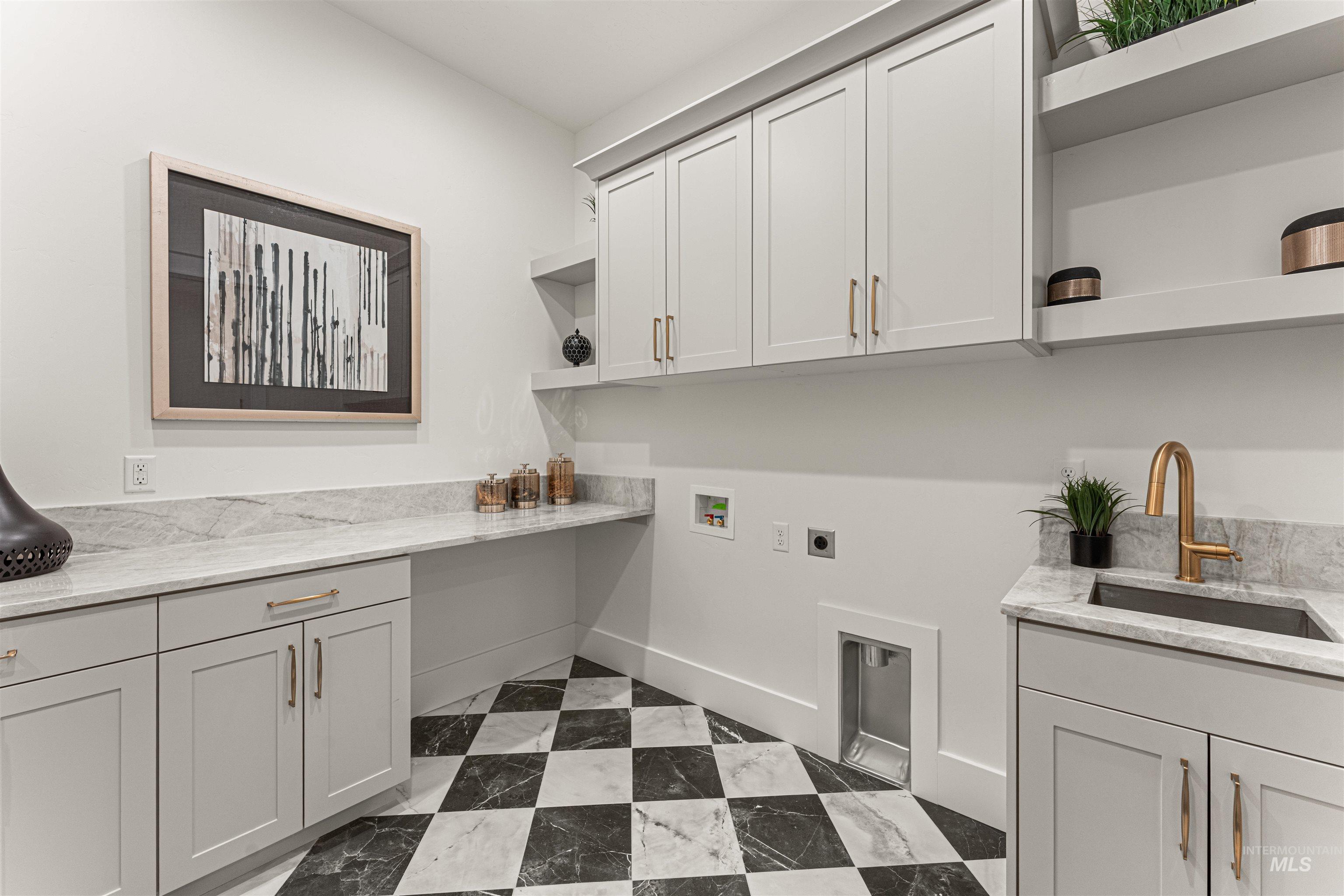 Laundry room with cabinet space, hookup for a washing machine, and hookup for an electric dryer