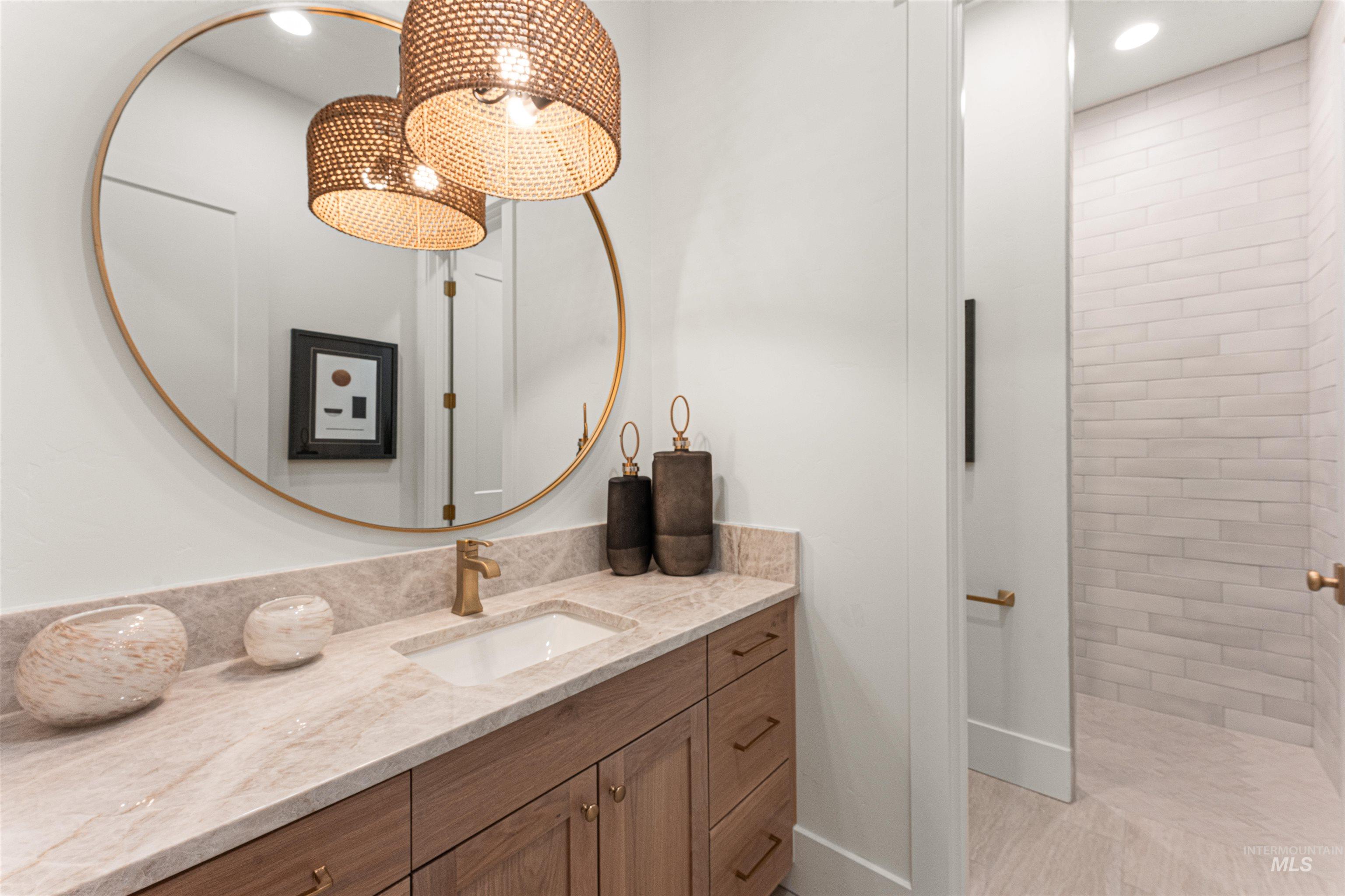 Bathroom with vanity, recessed lighting, and tiled shower