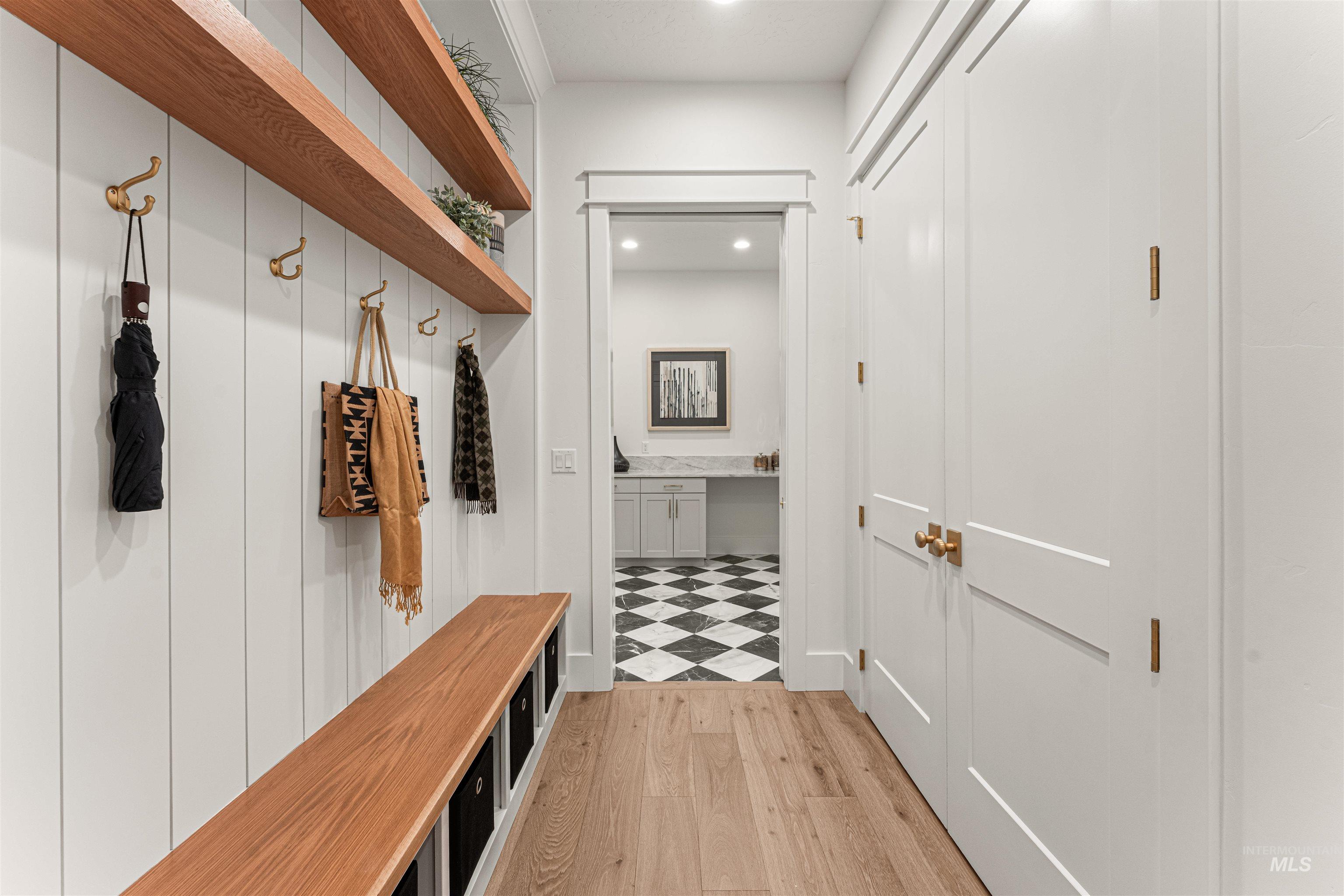 Mudroom featuring light wood finished floors and recessed lighting