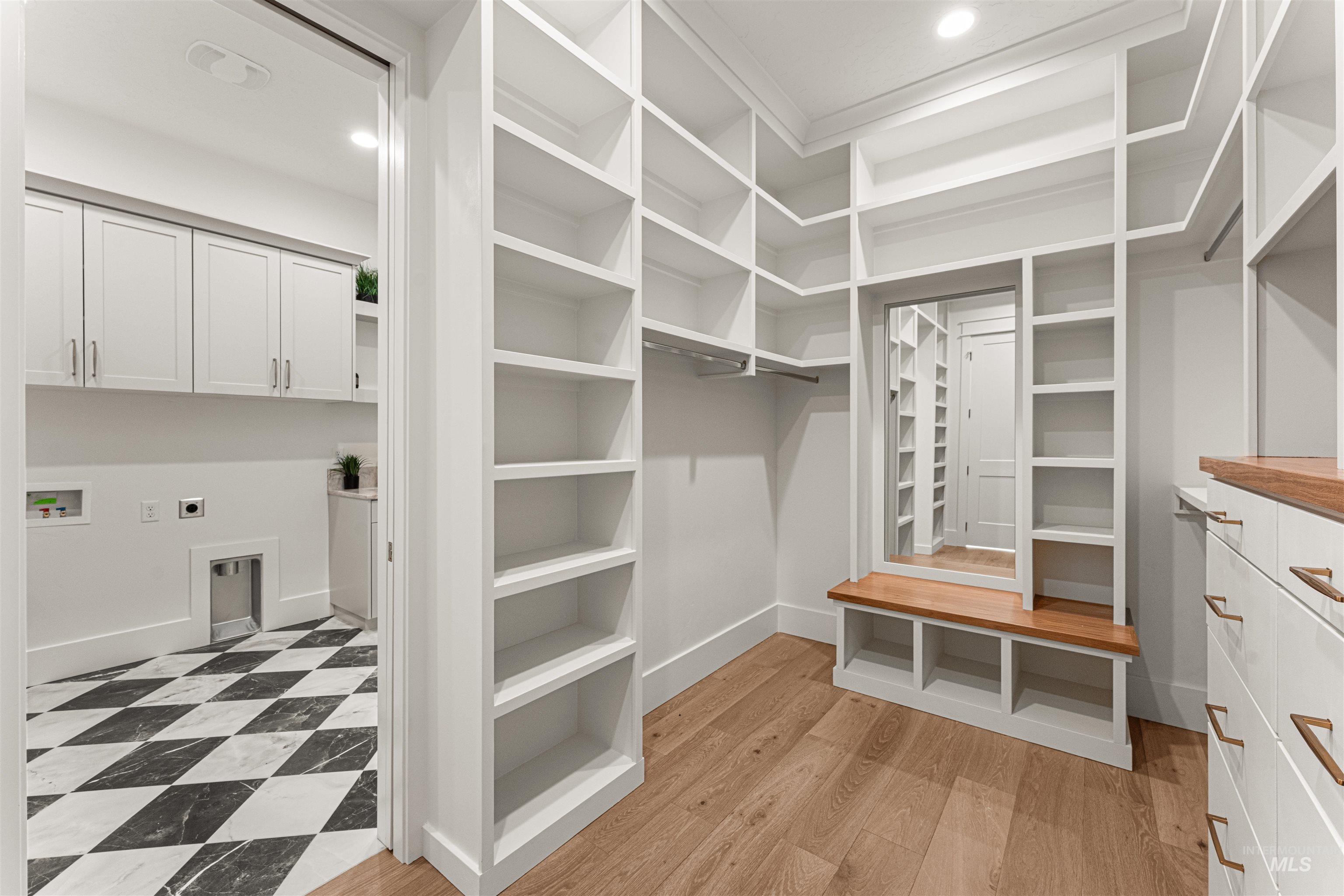 Walk in closet with light wood-type flooring