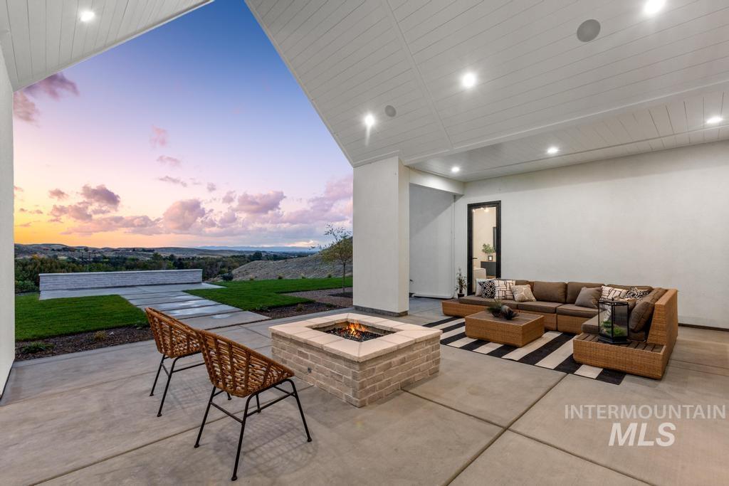 Patio terrace at dusk with a patio and an outdoor living space with a fire pit