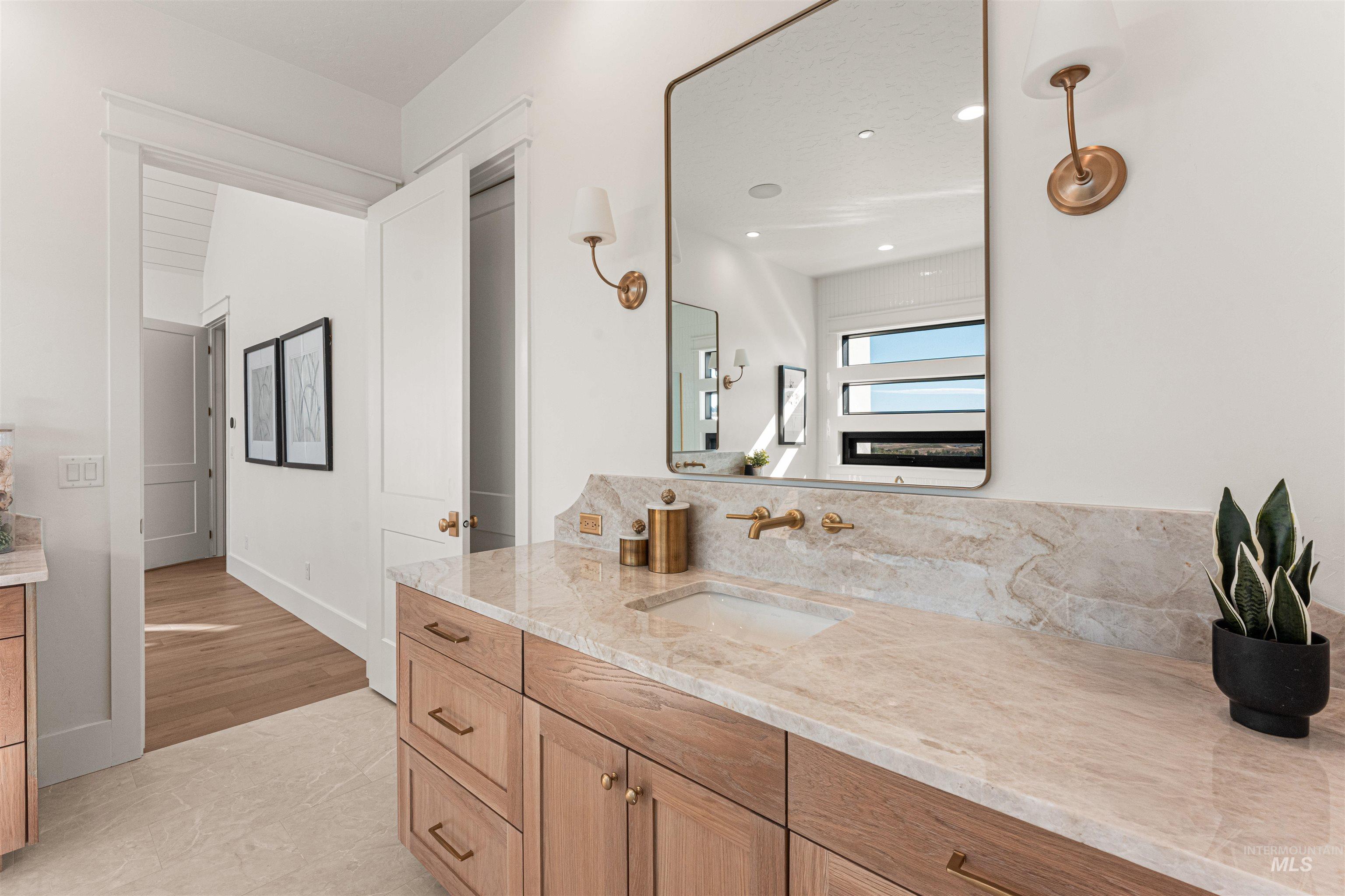Bathroom featuring vanity, light tile patterned floors, and recessed lighting