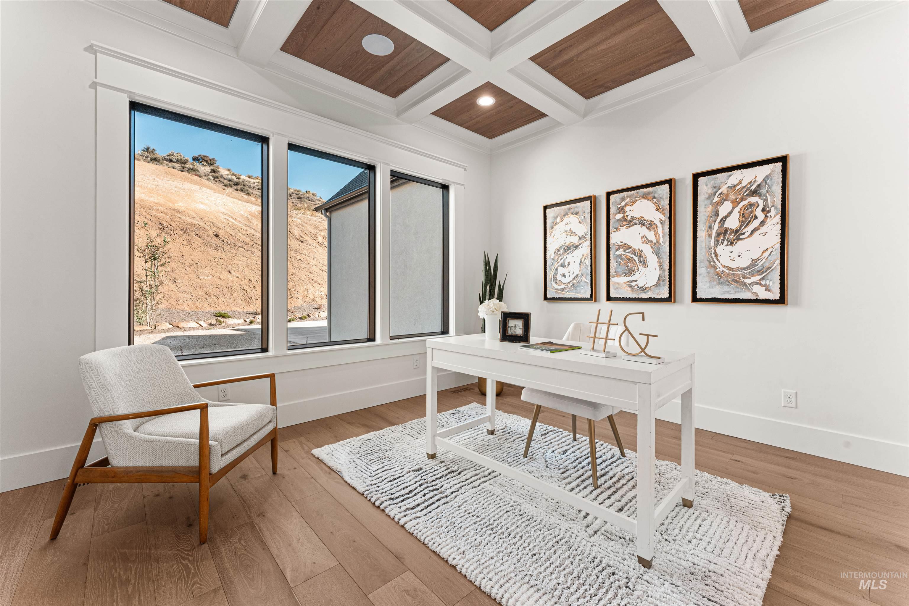 Office area with coffered ceiling, light wood-style floors, recessed lighting, ornamental molding, and a wooden ceiling with exposed beams